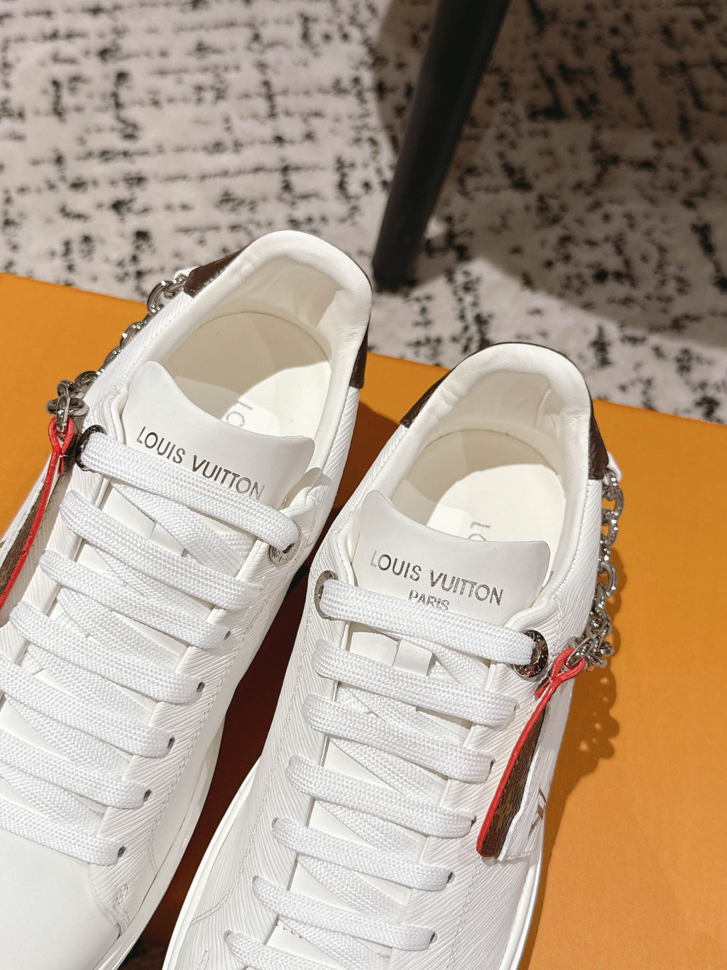 White Louis Vuitton lace-up sneakers with silver chain and tongue logo