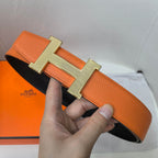 Orange leather belt with gold H buckle and rounded strap end