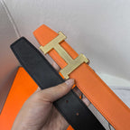 Reversible leather belt showing black strap underside and gold H buckle