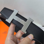 Leather belt with silver H buckle, dark textured strap and stitching detail