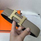 Gray leather belt with gold H buckle and smooth strap with keeper loops