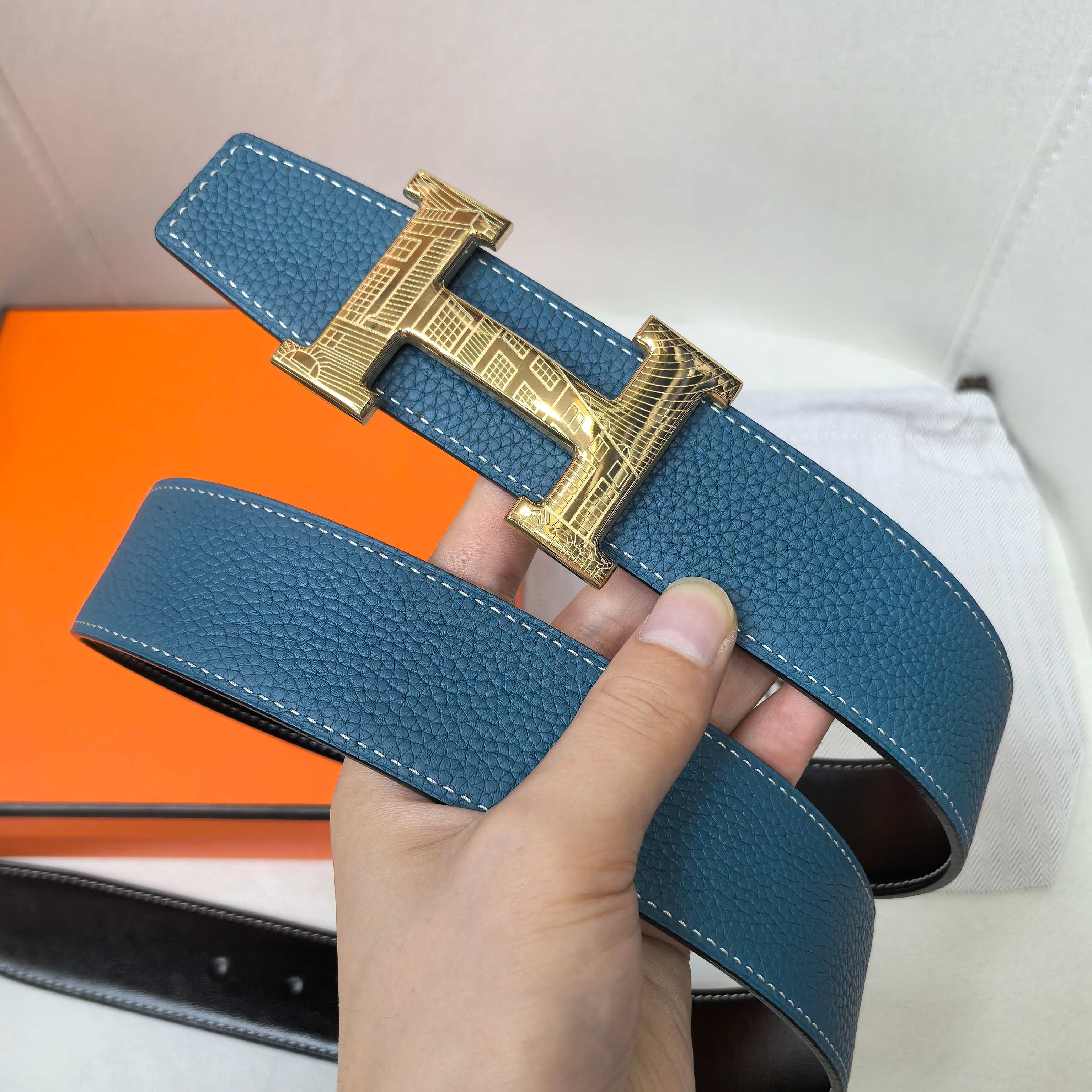 Hermes belt in textured blue leather with gold-tone H buckle and wide strap