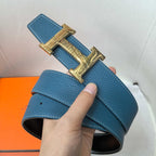 Hermes belt in textured blue leather with gold-tone H buckle, strap end view