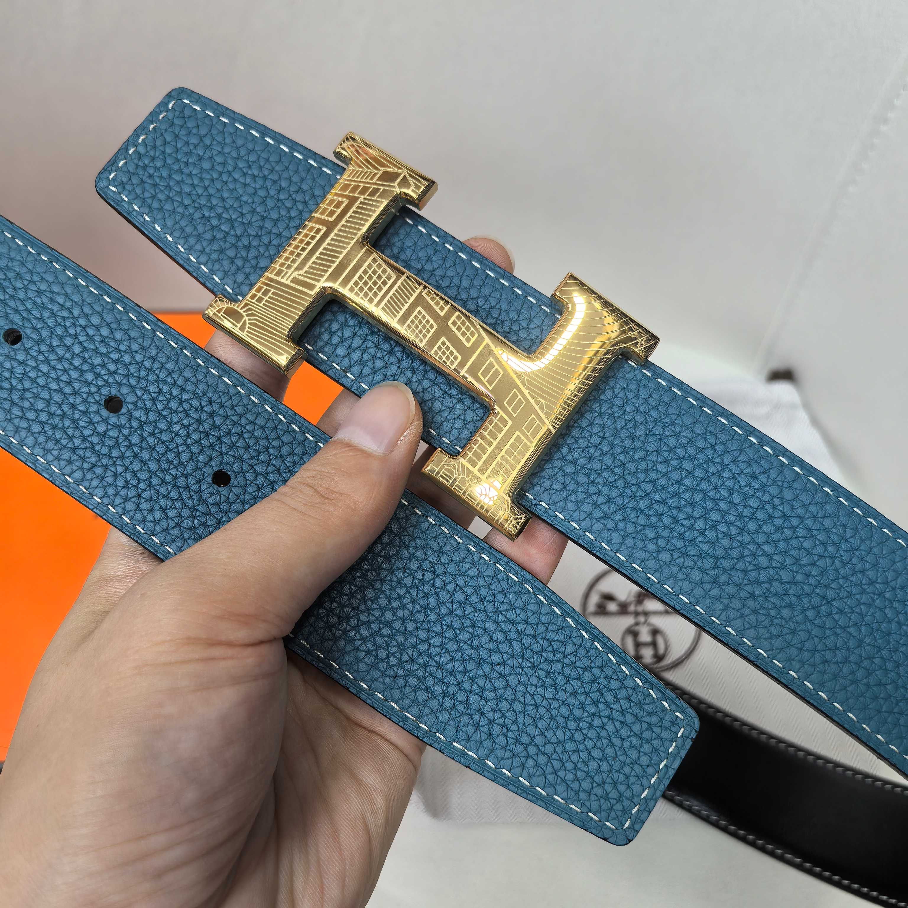 Hermes blue leather belt with gold-tone H buckle and adjustment holes