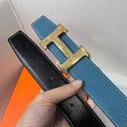 Hermes blue leather belt with gold-tone buckle; black leather strap with holes