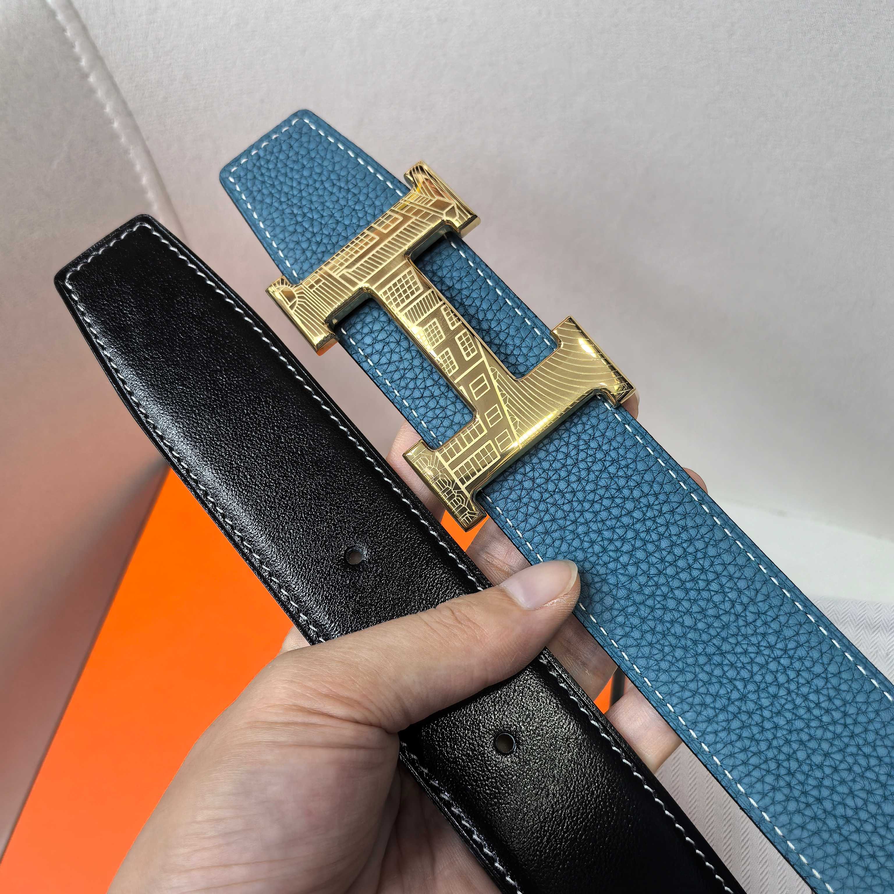 Hermes blue leather belt with gold-tone buckle; black leather strap with holes