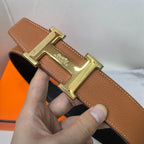 Hermes belt tan leather with gold-tone clasp buckle centered on strap.