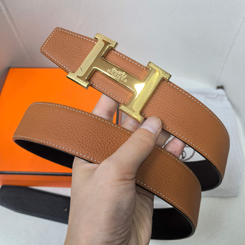 Hermes belt tan leather with gold-tone buckle and contrast stitching on strap.