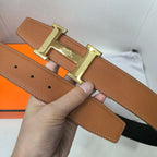 Hermes belt tan leather with perforated keeper holes and gold-tone buckle.