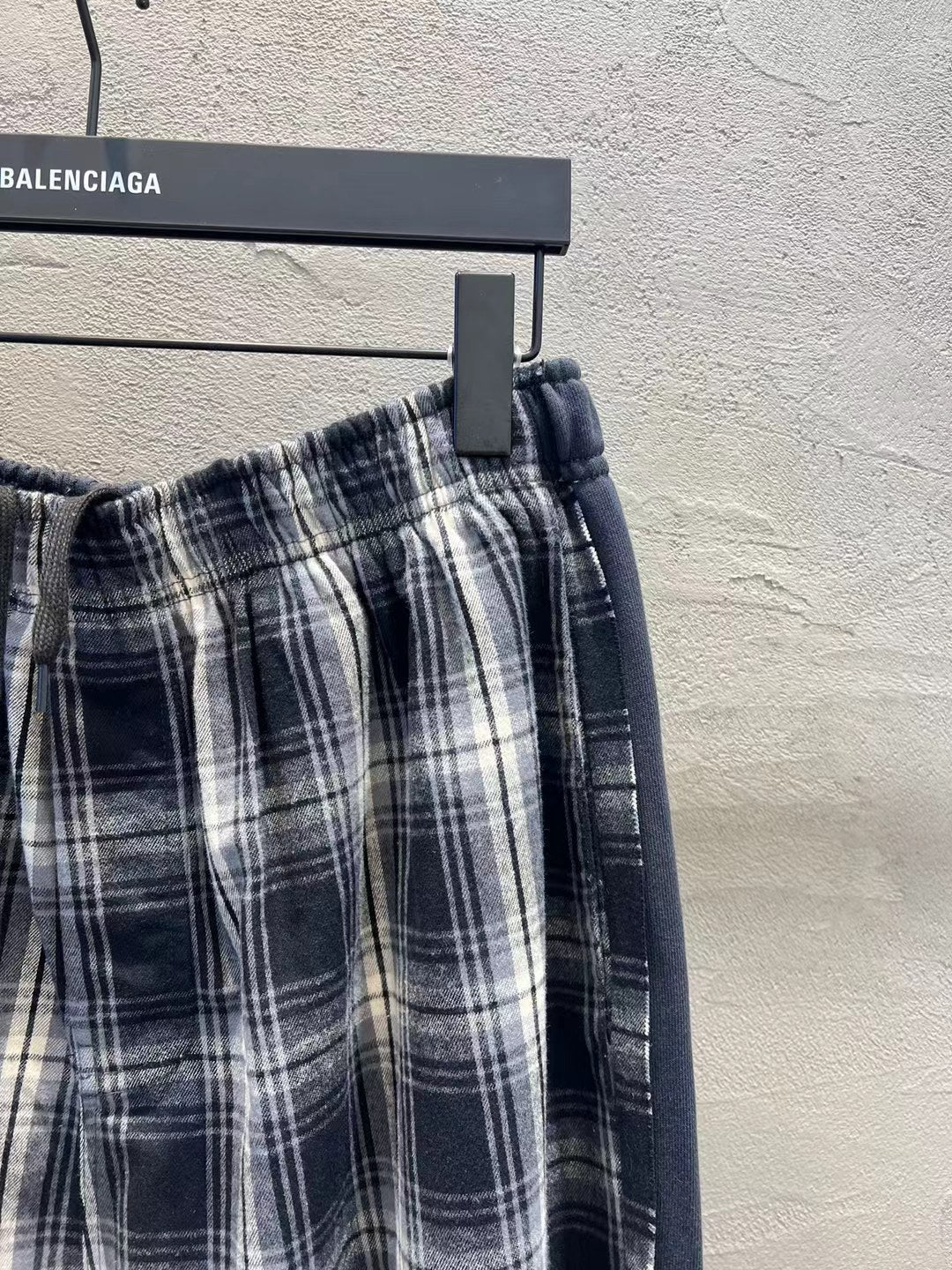 Plaid pants waistband with elastic and drawstring, close-up check pattern