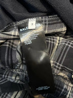 Plaid pants close-up with BALENCIAGA size label and inner care tag