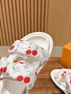 Louis Vuitton slide sandals close-up, white cherry-print straps over padded footbed