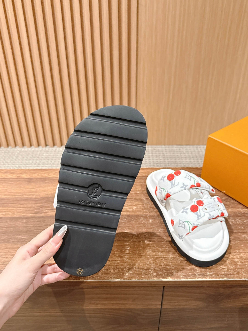 Louis Vuitton slide sandals outsole, textured dark rubber tread with embossed mark