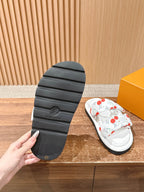 Louis Vuitton slide sandals outsole, textured dark rubber tread with embossed mark