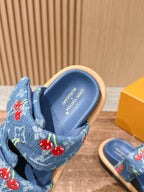 Louis Vuitton blue denim sandal close-up, logo footbed and cherry strap detail