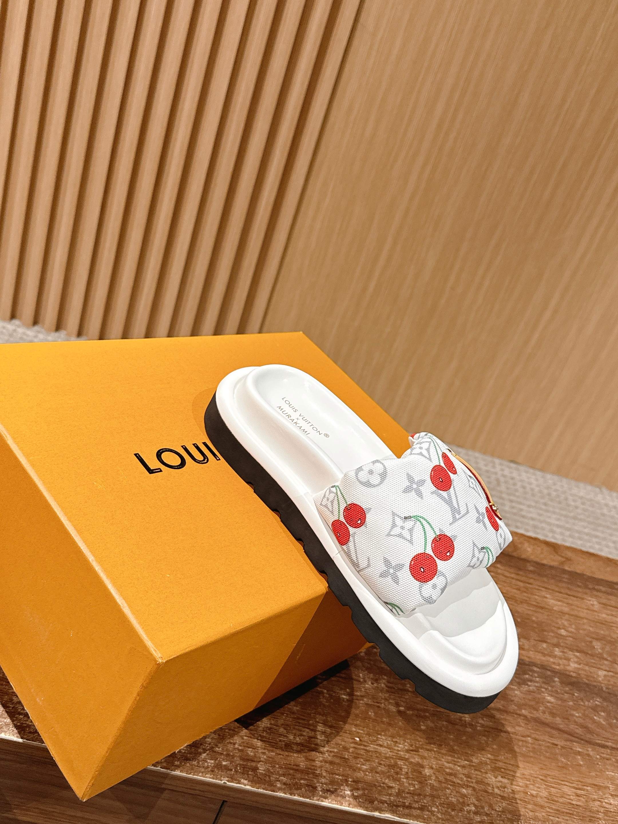 Cherry-print slide sandal with white footbed and tan leather tab on strap