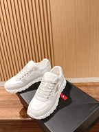 Prada unisex white sneakers, angled view with lace-up top and cushioned heel