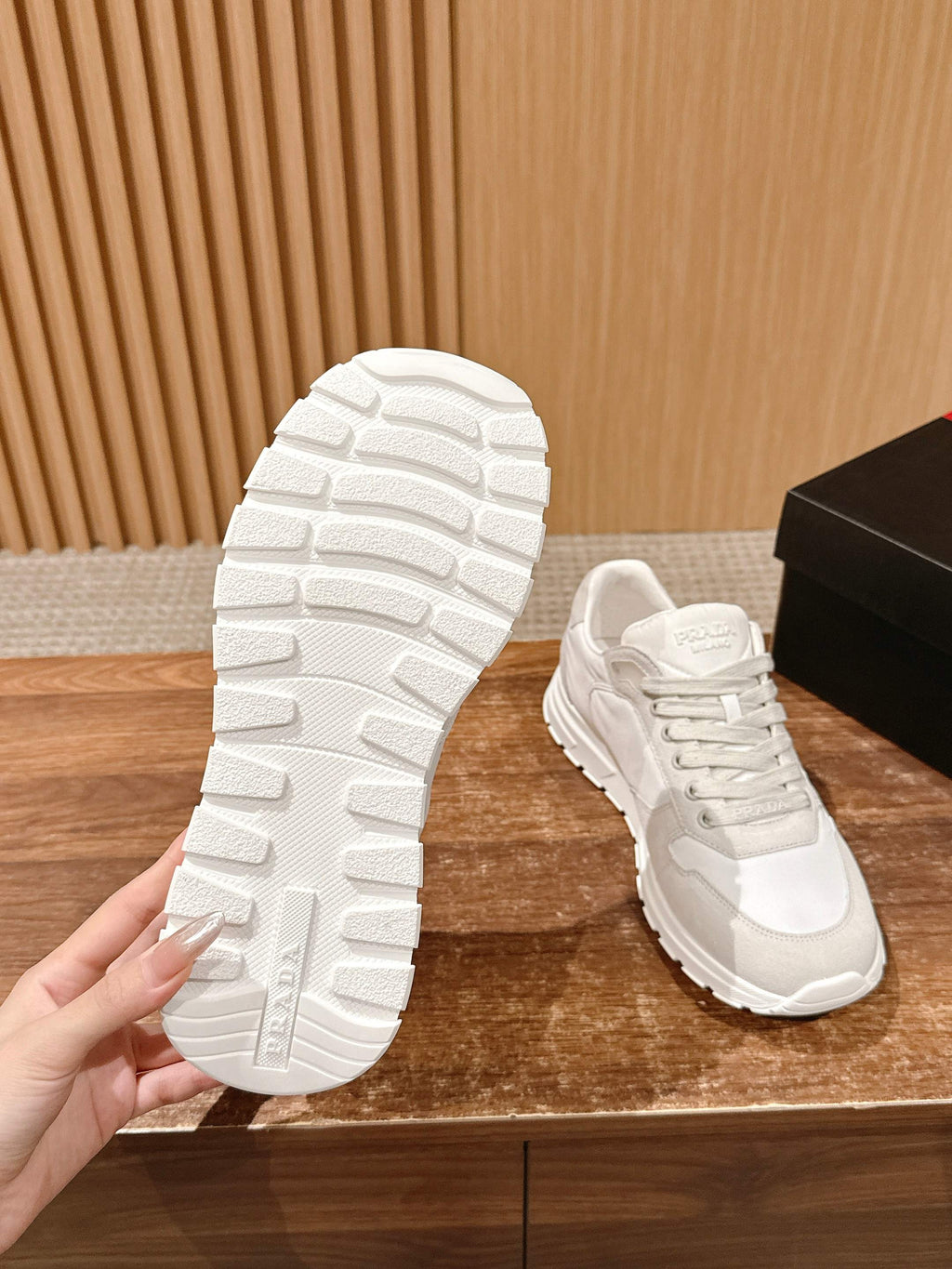 Prada unisex white sneakers, outsole view with deep tread and sidewall