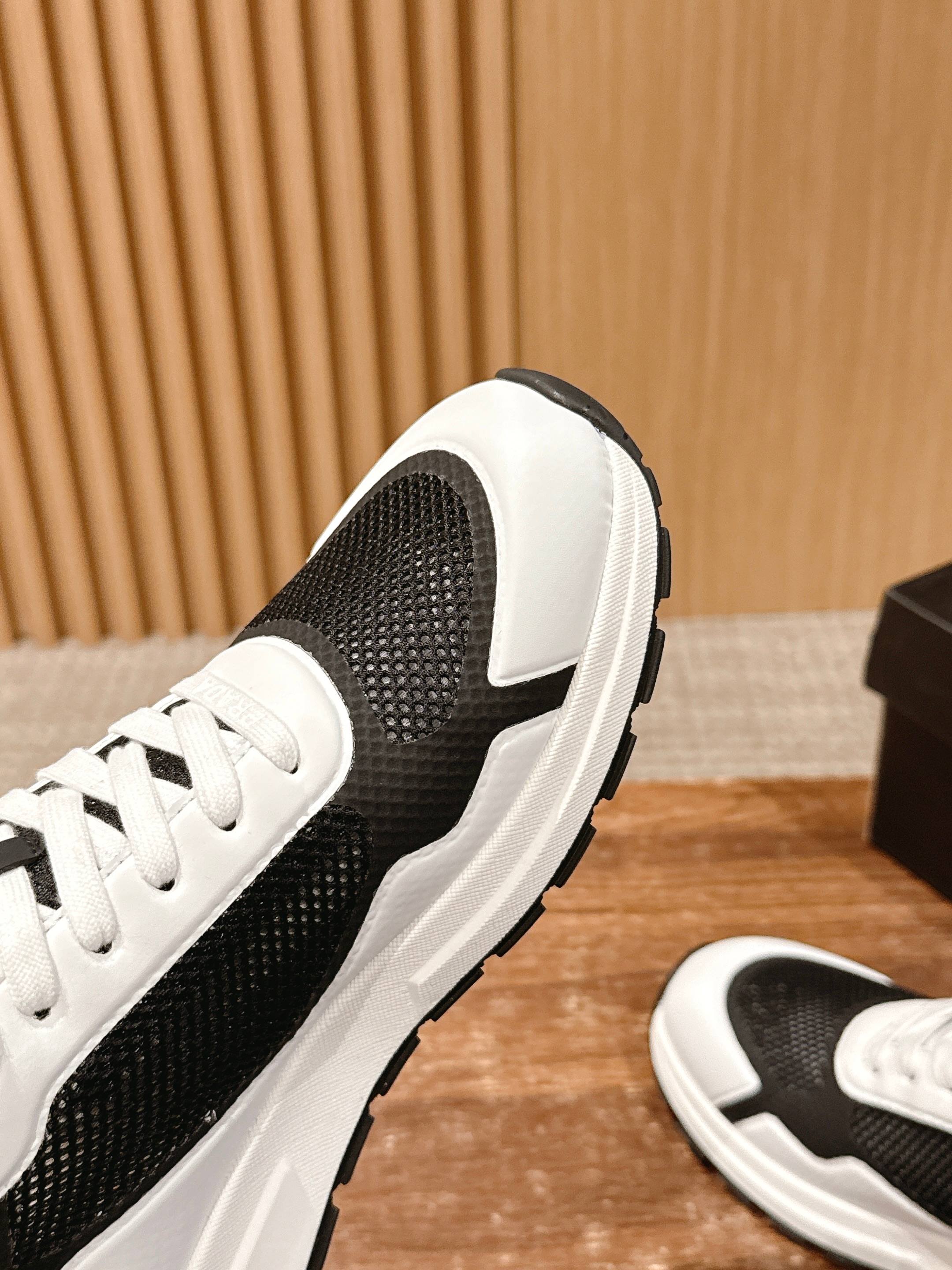 Close-up of black mesh and white leather-trim unisex sneaker side profile