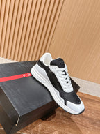 Black and white unisex lace-up sneakers on display box with white rubber sole
