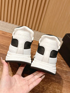 Unisex white-and-black sneakers with heel branding and padded collar