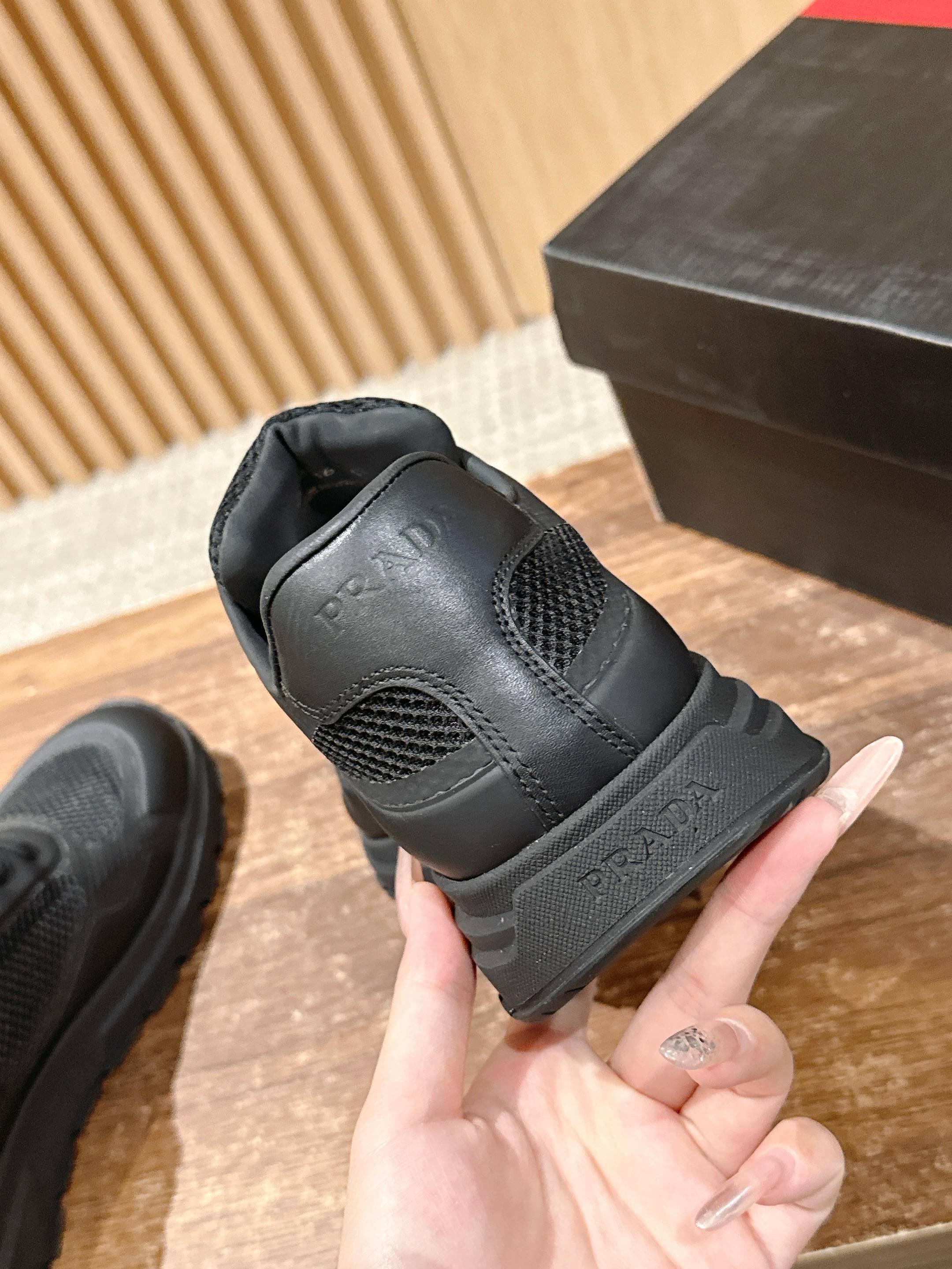 Black lace-up sneaker heel view with cushioned back and textured sole