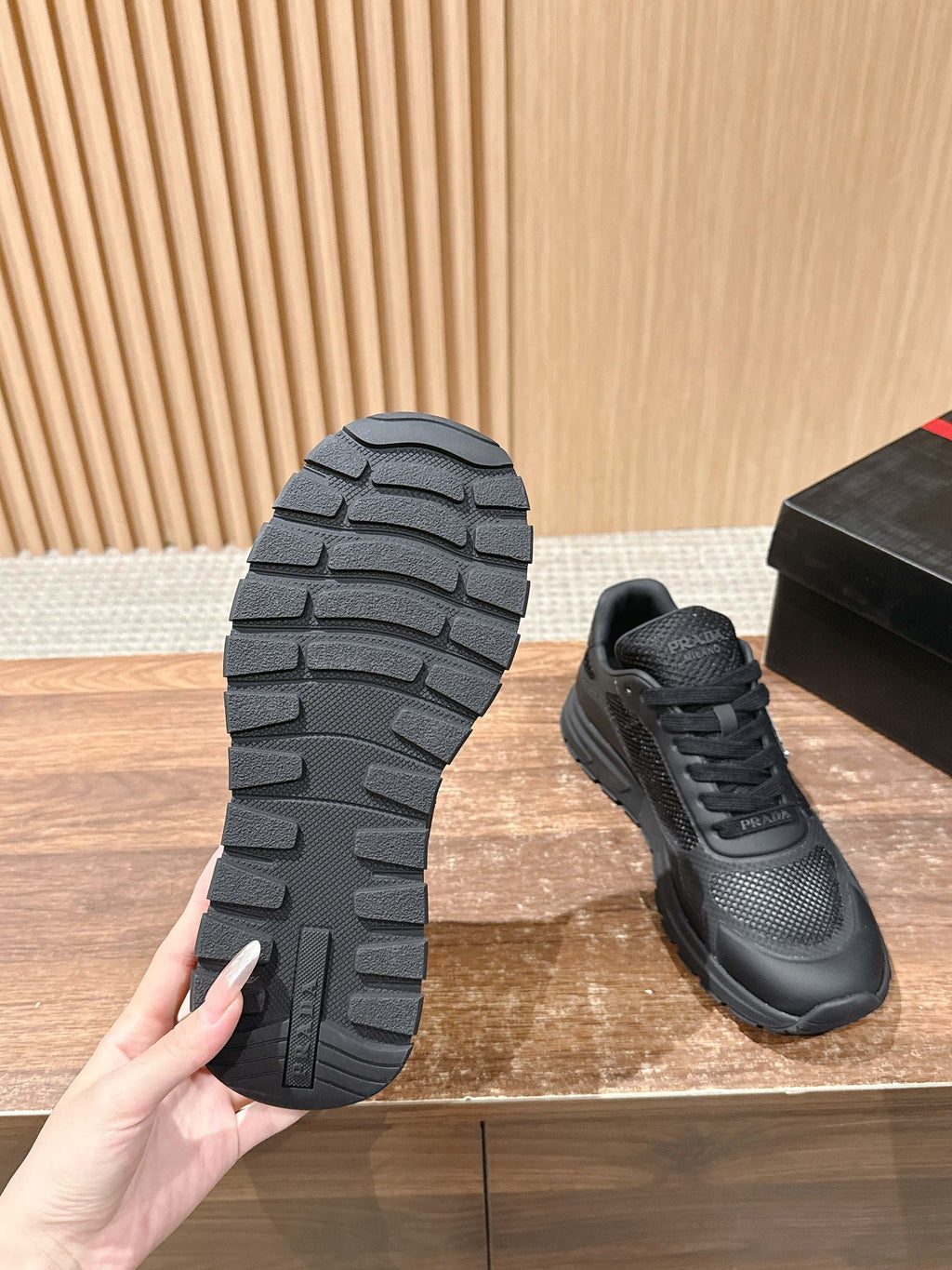 Black sneaker outsole tread and lace-up pair, rubber sole detail shown