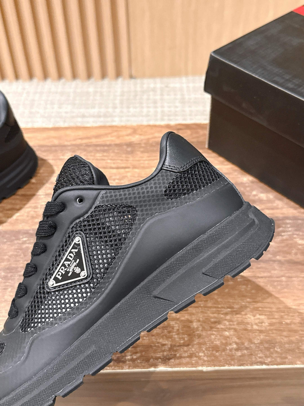 Black lace-up sneaker with side logo patch and textured mesh upper