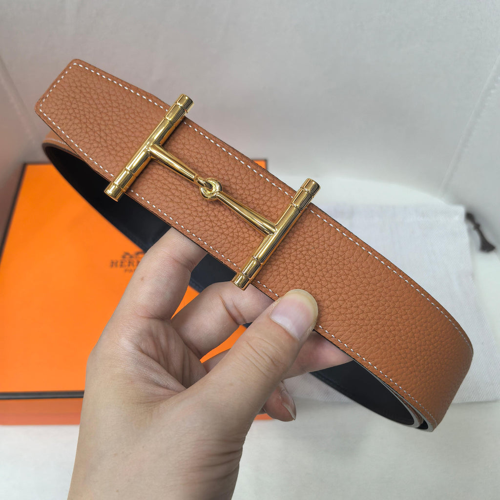 Brown leather belt with gold-tone buckle and textured strap detail