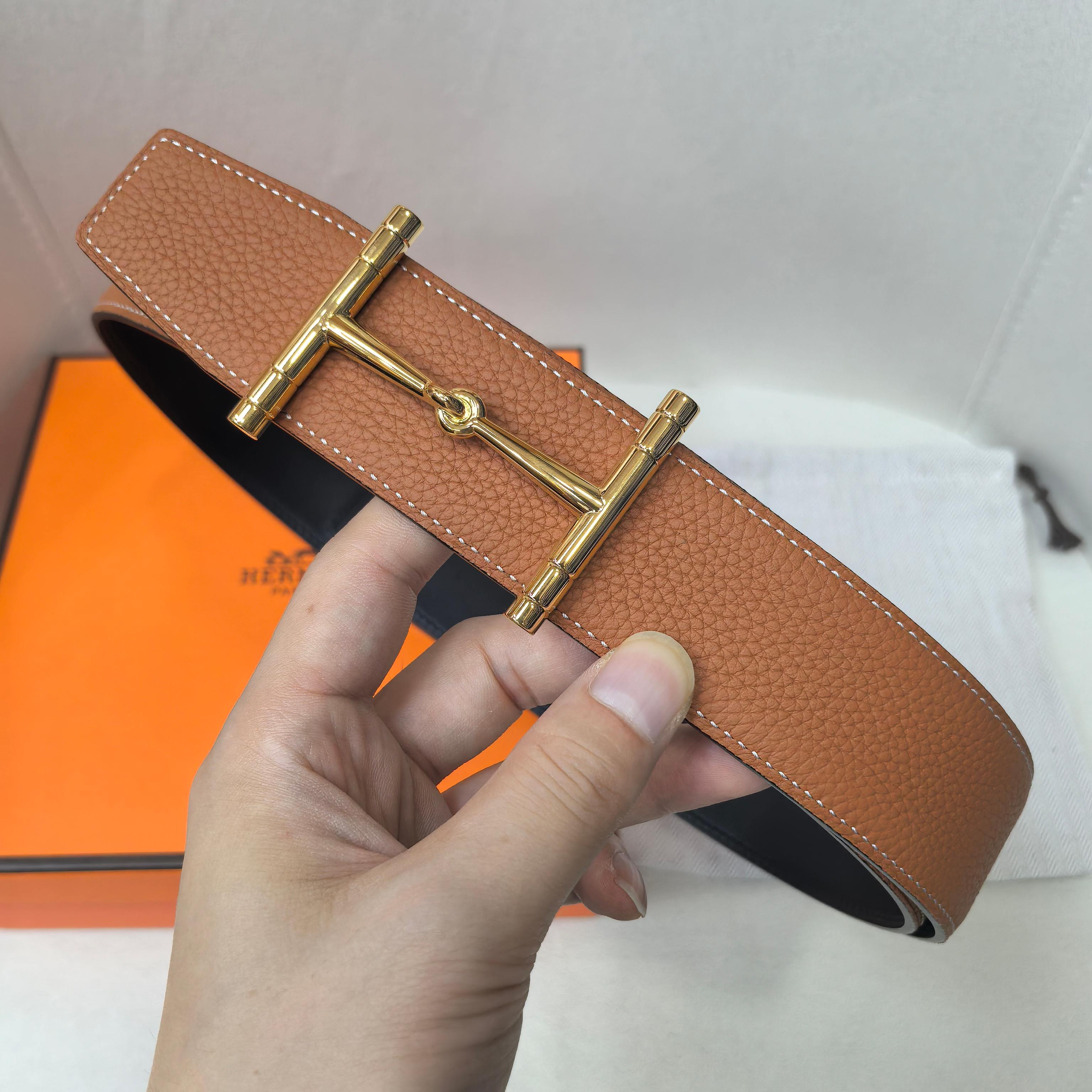 Brown leather belt with gold-tone buckle and textured strap detail