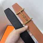 Brown and black leather belts with gold-tone buckle, shown side by side