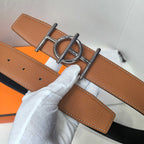 Leather belt close-up: tan/brown strap with silver buckle and keeper detail