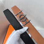Leather belt with black and tan sides and silver buckle; stitched edges