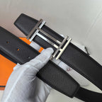 Leather belt with textured black leather and silver-tone buckle, detail view