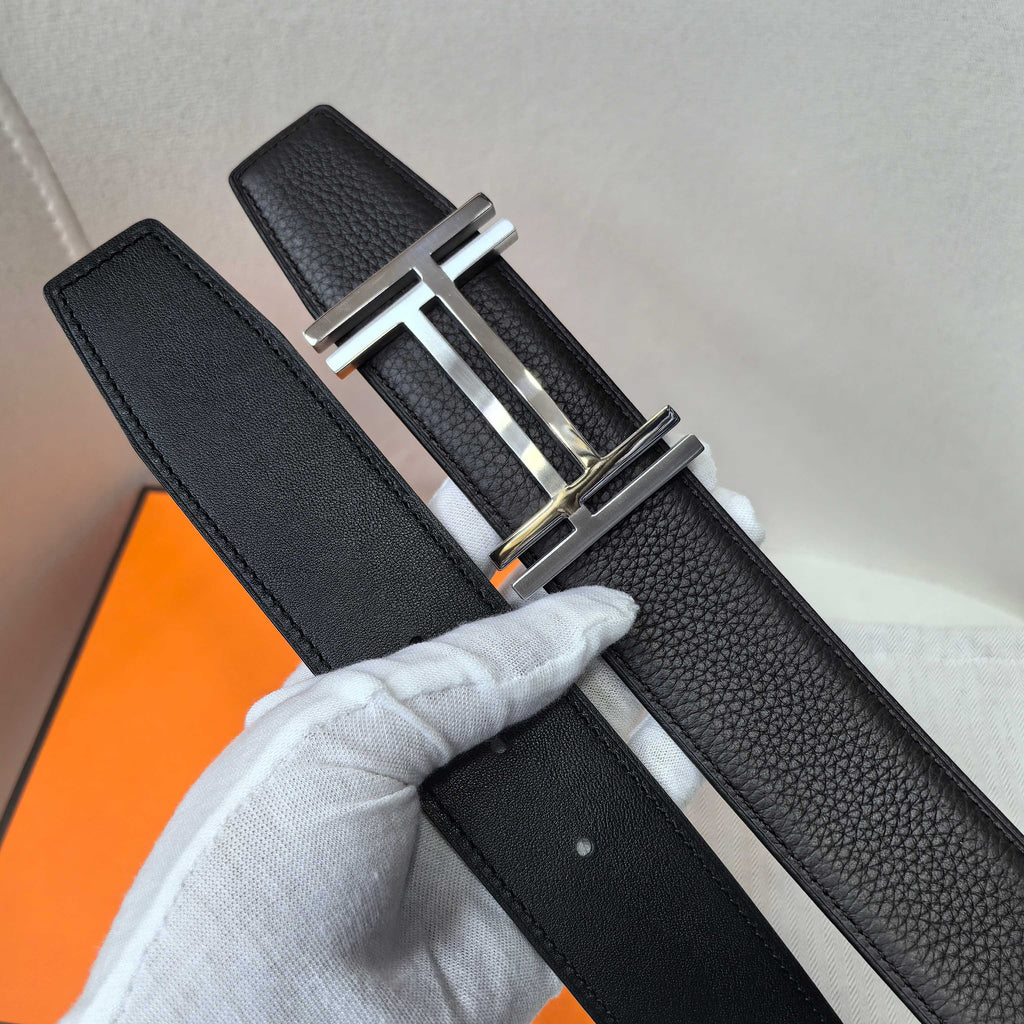 Leather belt with textured black leather and silver-tone buckle, full length view