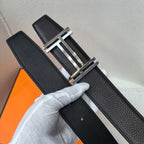 Leather belt with textured black leather and silver-tone buckle, full length view