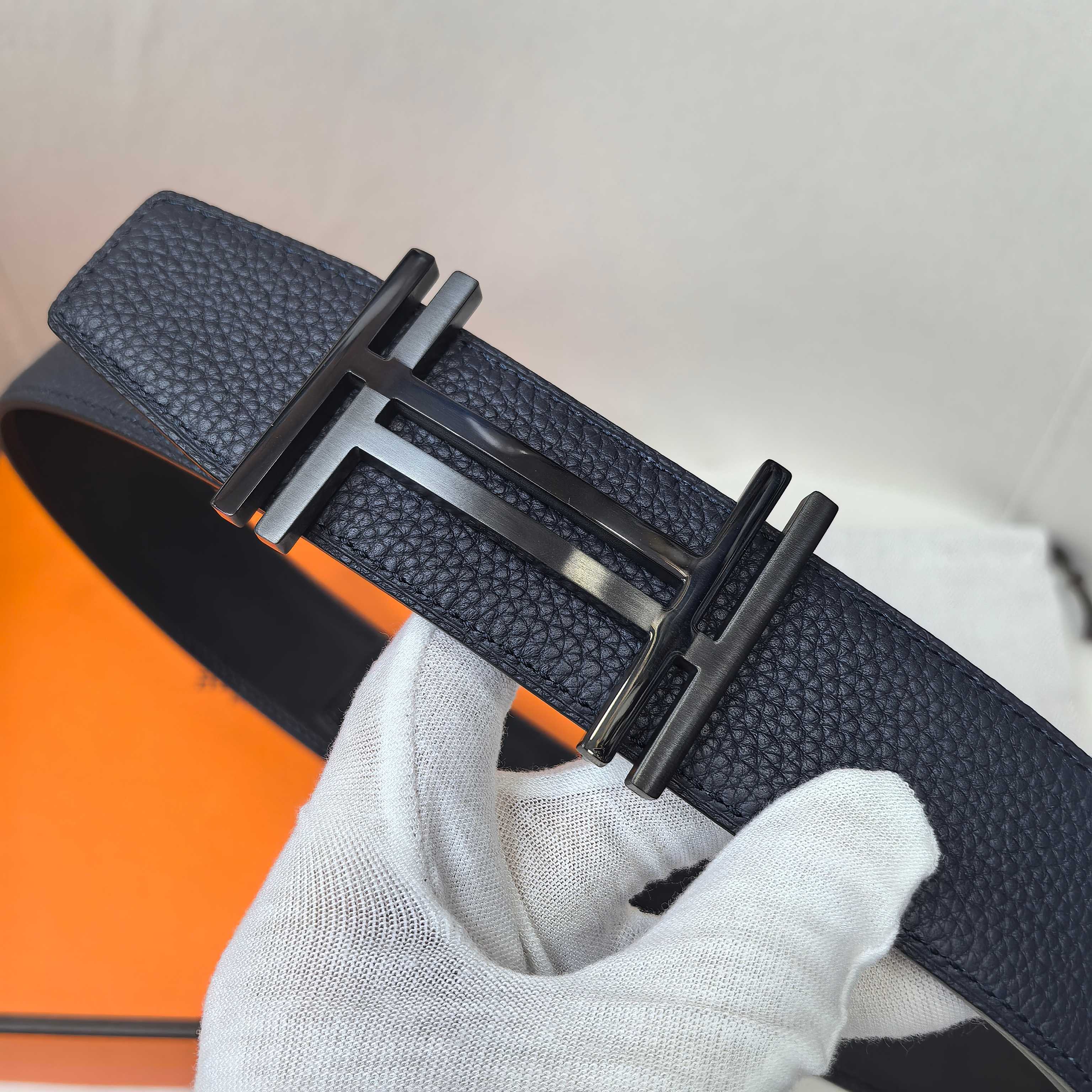 Navy leather belt with silver-tone buckle detail