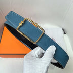 Leather belt, blue textured leather with gold buckle over black backing.