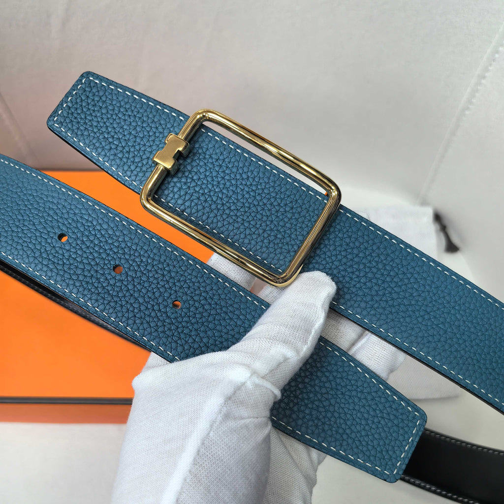 Leather belt, blue textured strap with gold buckle and visible adjustment holes.
