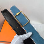 Leather belt set, blue and black textured straps with matching gold buckles.