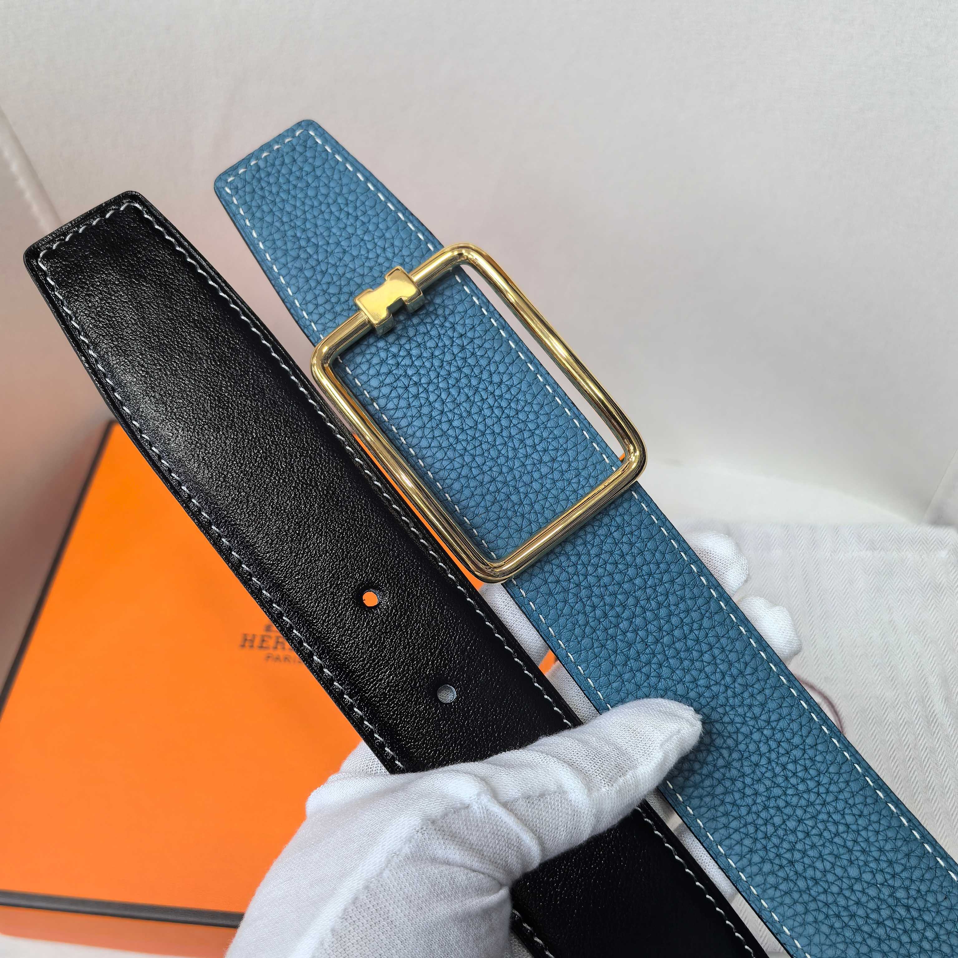 Leather belt set, blue and black textured straps with matching gold buckles.