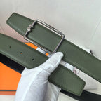 Green leather belt with silver rectangular buckle and punched holes