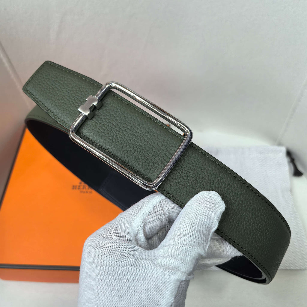 Green leather belt with silver buckle and curved keeper strap