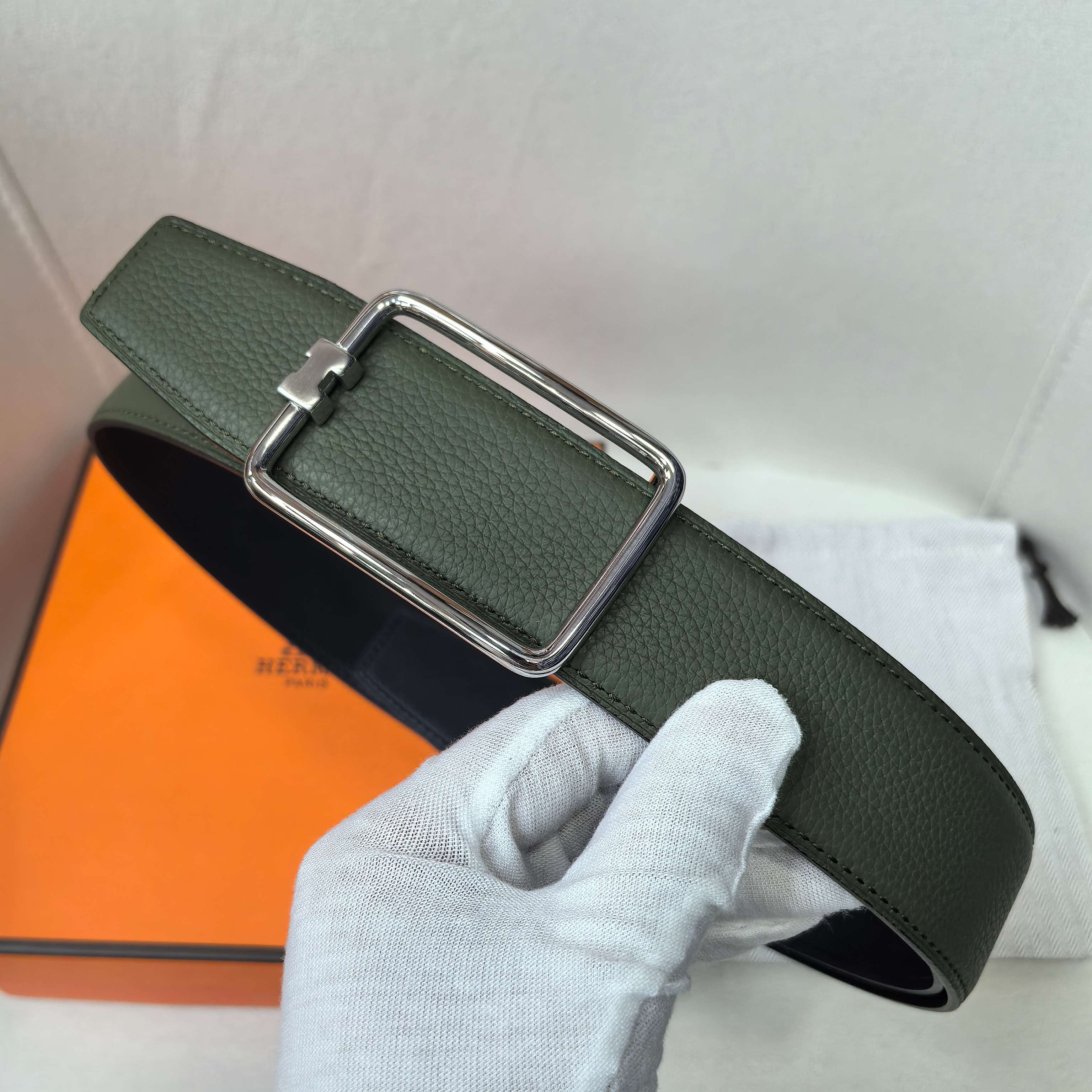 Green leather belt with silver buckle and curved keeper strap