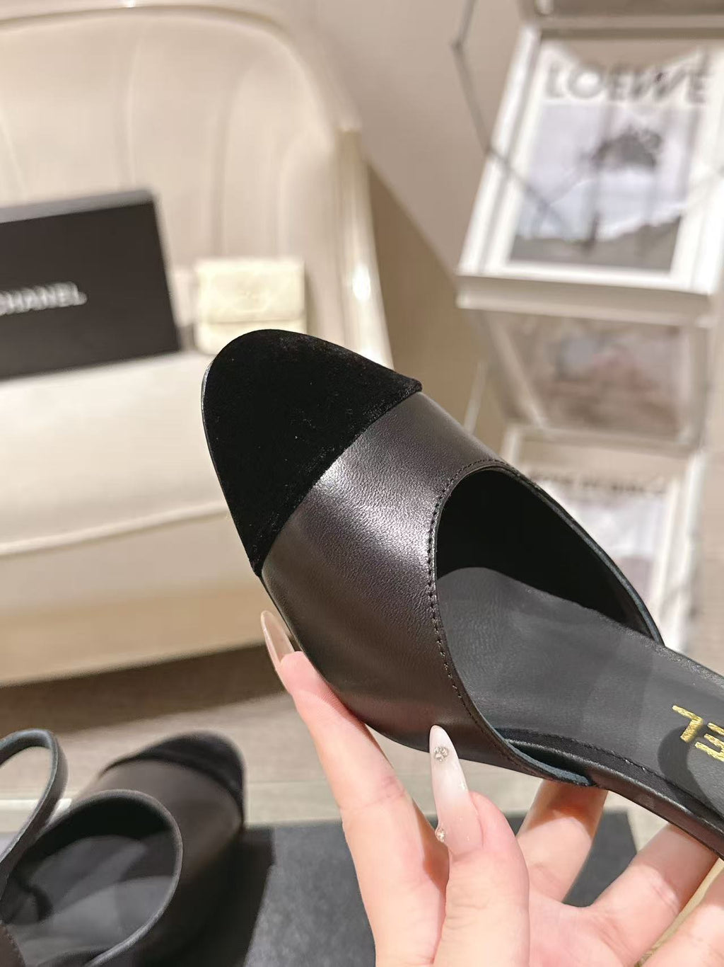 Women's black heeled sandal close-up, pointed toe and smooth leather-like upper