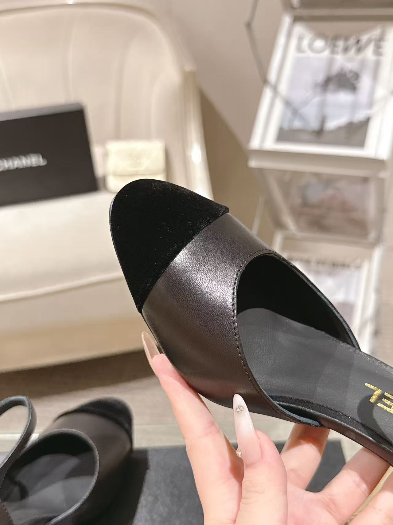Women's black heeled sandal close-up, pointed toe and smooth leather-like upper