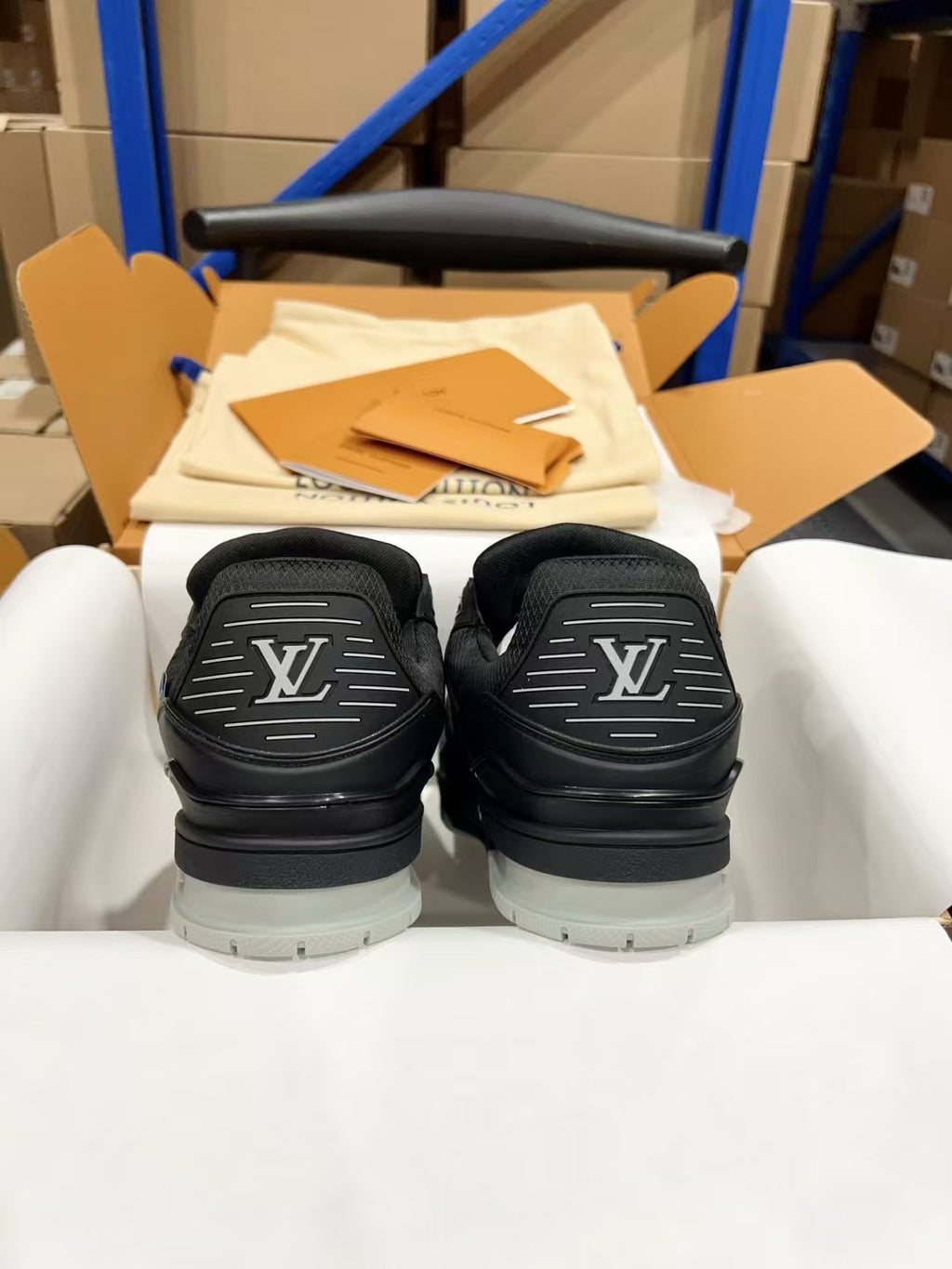 Back view of black Louis Vuitton trainer shoes showing rear logo