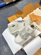 White Louis Vuitton trainer shoes, side and heel view with tread panel logo.
