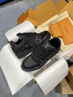 Louis Vuitton black lace-up sneakers with monogram overlays and thick sole