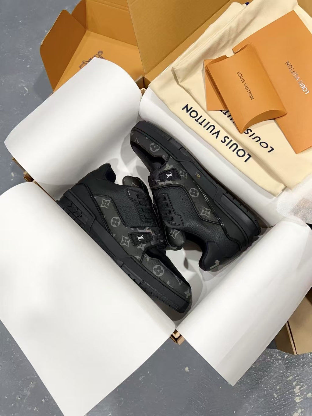Louis Vuitton black lace-up sneakers with textured monogram pattern